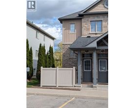 A house with a grey front door and a sign that says "No Parking" in front of it.