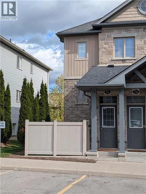 A house with a grey front door and a sign that says "No Parking" in front of it.