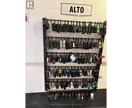 A brokerage rack with many locks and a sign that says Alto.