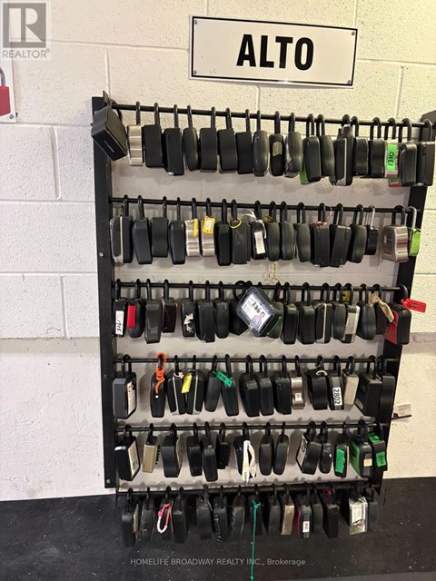 A brokerage rack with many locks and a sign that says Alto.