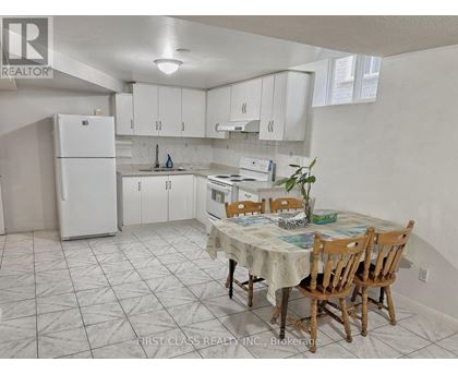 A kitchen with a table and chairs in the middle of the room.