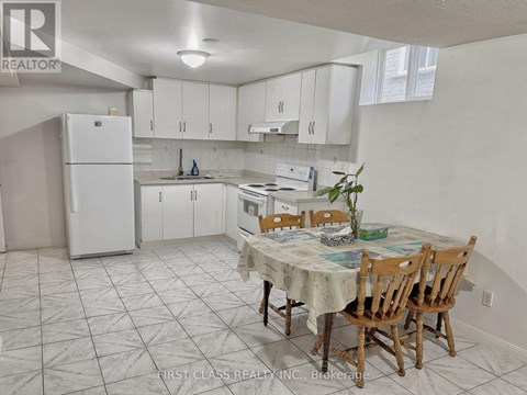 A kitchen with a table and chairs in the middle of the room.