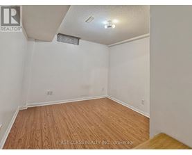 A room with wooden flooring and white walls.