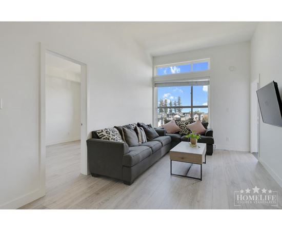 A living room with a grey couch and a coffee table.