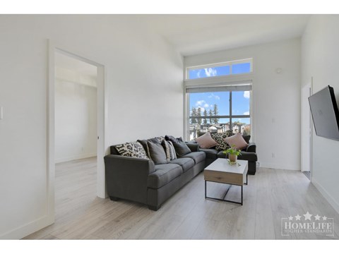 A living room with a grey couch and a coffee table.