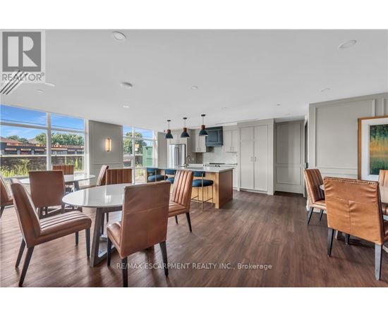 A modern dining room with a glass table and chairs.