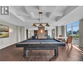 A pool table in a room with a billiard table in the middle.