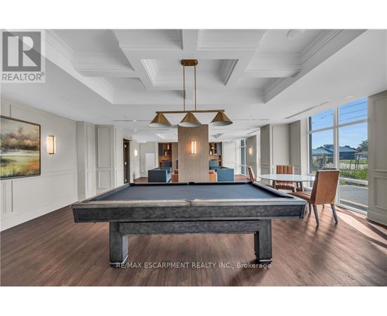 A pool table in a room with a billiard table in the middle.