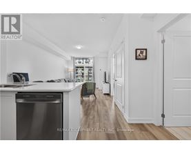 A modern kitchen with white cabinets and a stainless steel dishwasher.