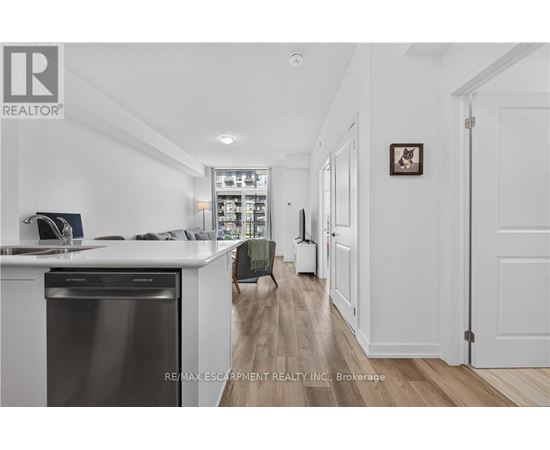 A modern kitchen with white cabinets and a stainless steel dishwasher.