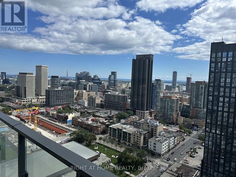 A cityscape with a view of the sky and buildings from a high vantage point.