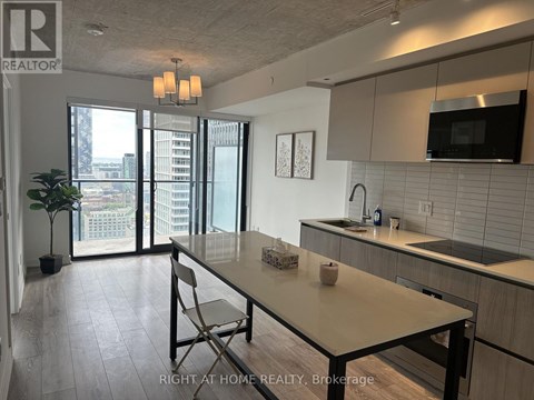 A modern kitchen with a dining table and chairs.