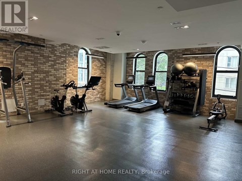 A gym with a brick wall and various exercise equipment.
