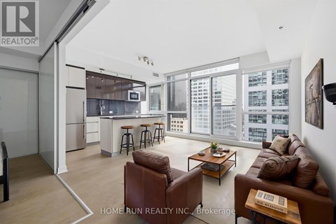 A living room with a brown leather couch and a coffee table.
