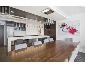 A modern dining room with a wooden table and chairs.