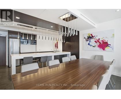 A modern dining room with a wooden table and chairs.