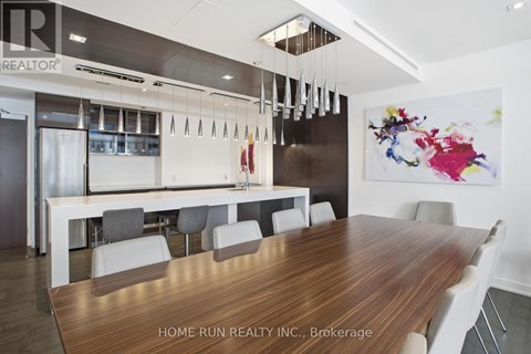 A modern dining room with a wooden table and chairs.