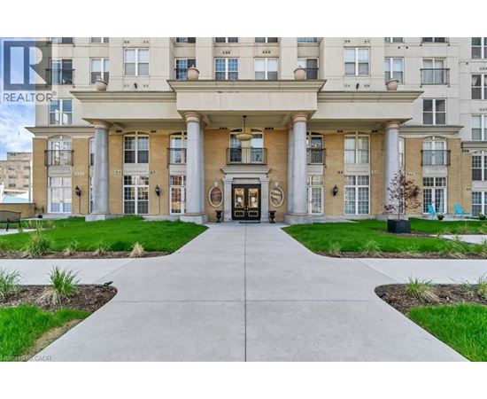 A building with a large front entrance and a walkway leading to it.