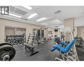 A well-equipped gym with various exercise machines and weights.