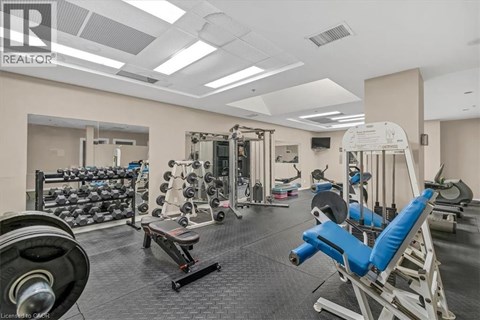 A well-equipped gym with various exercise machines and weights.