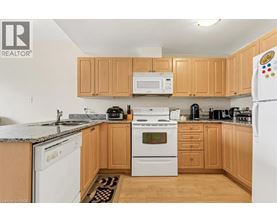 A kitchen with wooden cabinets and white appliances.