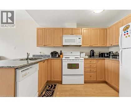 A kitchen with wooden cabinets and white appliances.