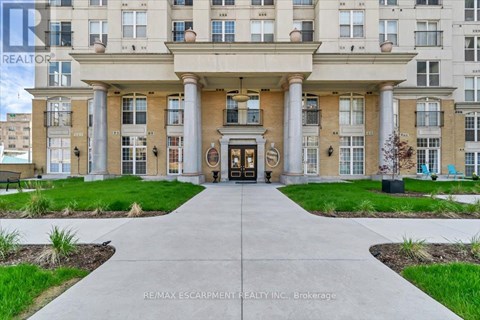 A building entrance with a walkway leading to it.