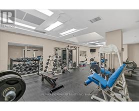 A gym with a variety of equipment including weights and machines.