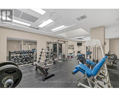 A gym with a variety of equipment including weights and machines.