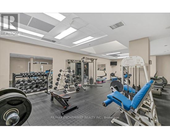 A gym with a variety of equipment including weights and machines.