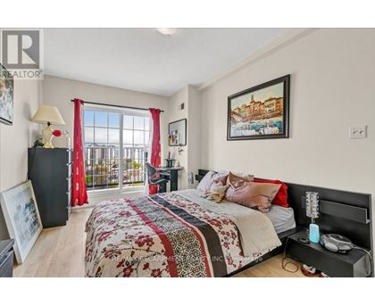 A bedroom with a large bed and a balcony with red curtains.