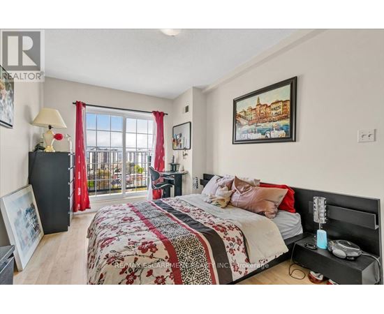 A bedroom with a large bed and a balcony with red curtains.