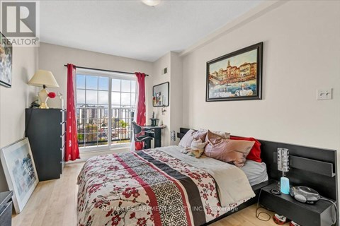 A bedroom with a large bed and a balcony with red curtains.