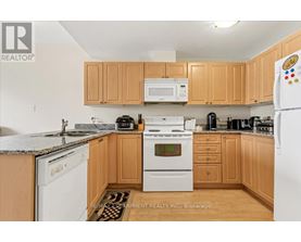A kitchen with wooden cabinets and a white refrigerator.
