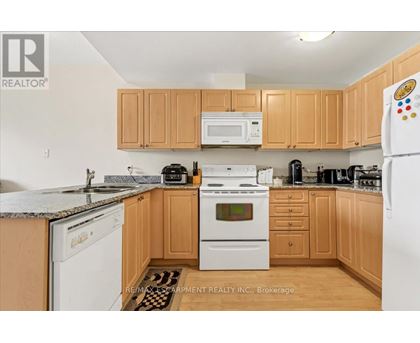 A kitchen with wooden cabinets and a white refrigerator.