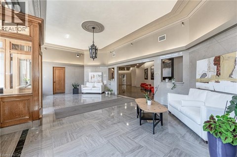 A living room with a white couch and a wooden coffee table.