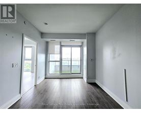 A room with a sliding glass door leading to a balcony.