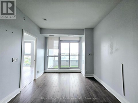A room with a sliding glass door leading to a balcony.