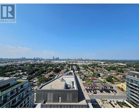A cityscape with a clear blue sky and a building with the logo REALTOR in the top left corner.