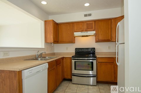 A kitchen with wooden cabinets and stainless steel appliances.