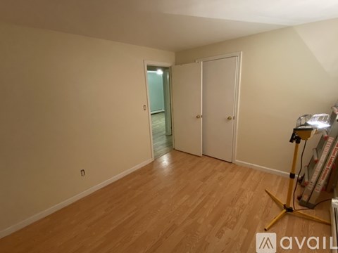 A room with wooden flooring and a white door.