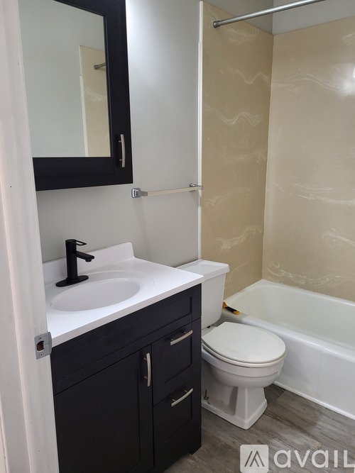 A bathroom with a sink, toilet, and bathtub.