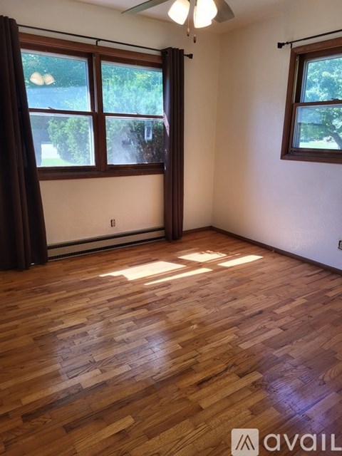 A room with wooden floors and windows.