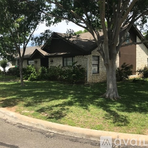 A house with a tree in front of it.