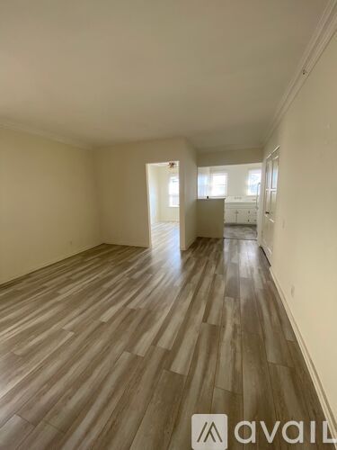 A room with wooden flooring and a logo that reads "avail" on the bottom right.