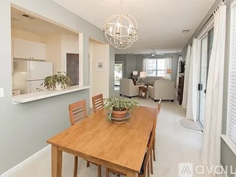 A dining room with a wooden table and chairs.