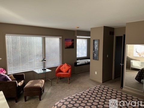 A living room with a brown chair and ottoman.