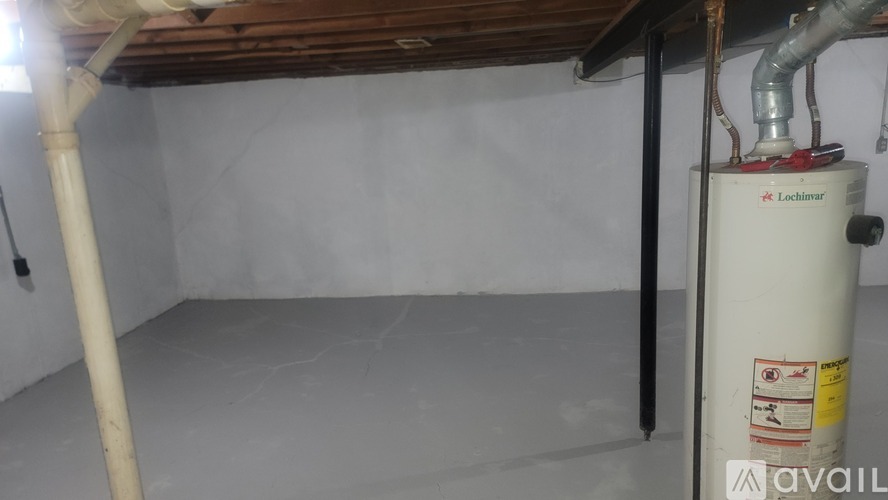 A room with a Lochinvar tank on the right side.