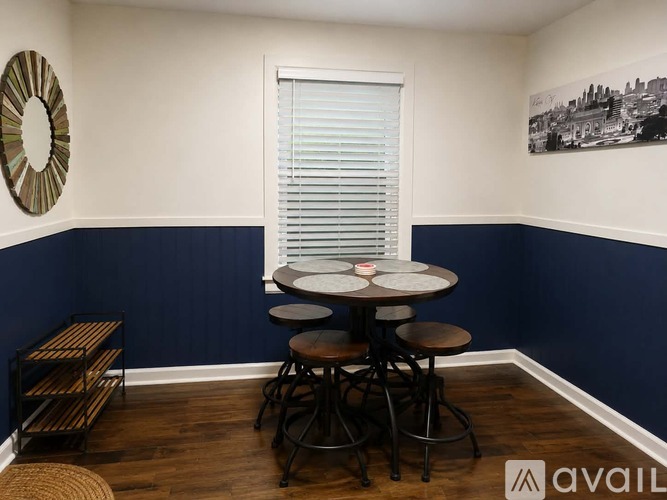 A dining area with a round table and chairs.
