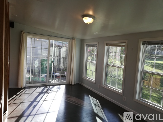 A room with a large window and a sliding glass door.